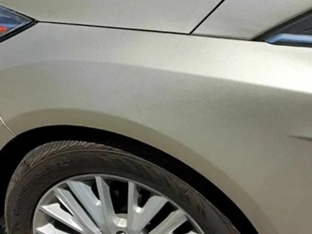 Champagne Ford rear quarter panel after dent repair