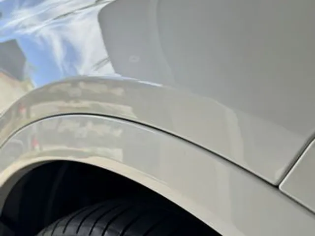 Champagne car rear quarter after dent repair