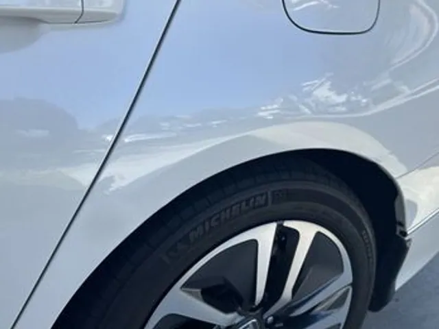Gray sedan rear quarter after dent repair