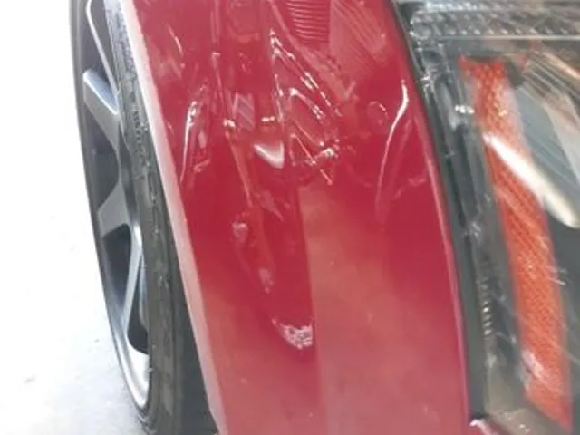 Red car rear quarter near the tail light after repair