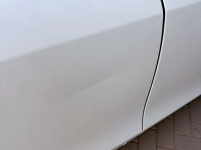 White car door panel after dent repair