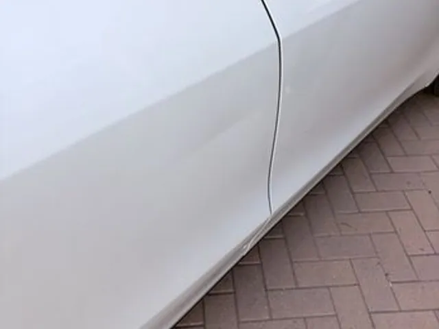 White car rocker panel after dent repair