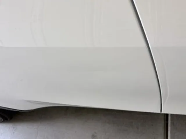 White car front fender after dent repair