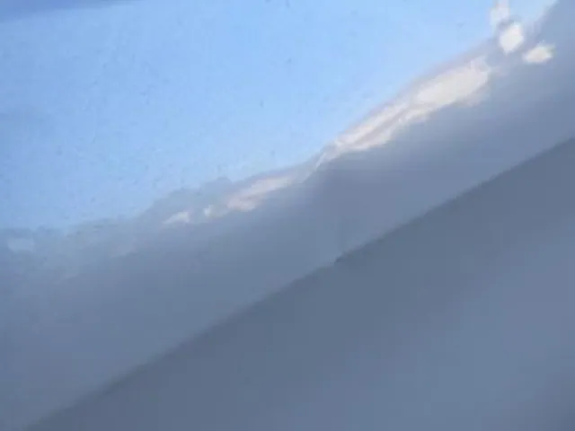 Silver car panel after dent repair