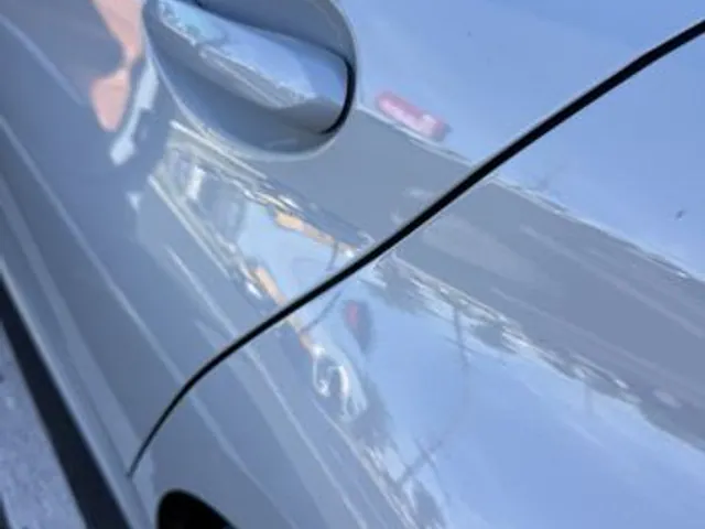 Gray sedan door after dent repair