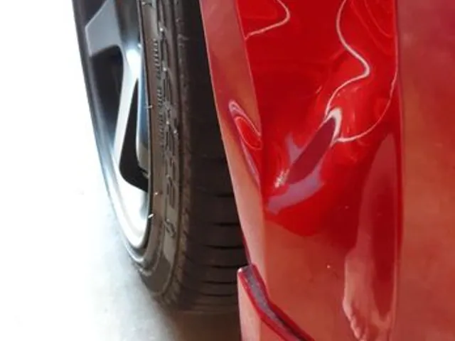Red car rear quarter after paintless dent repair
