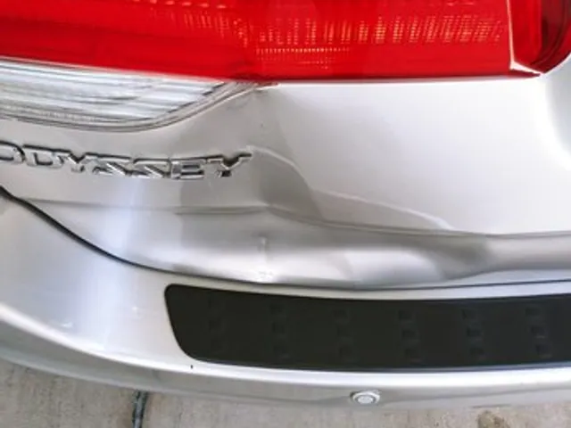 Dent on a Honda Odyssey rear bumper before repair