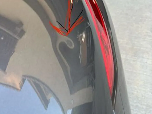 Dent marked near a tail light before paintless dent repair
