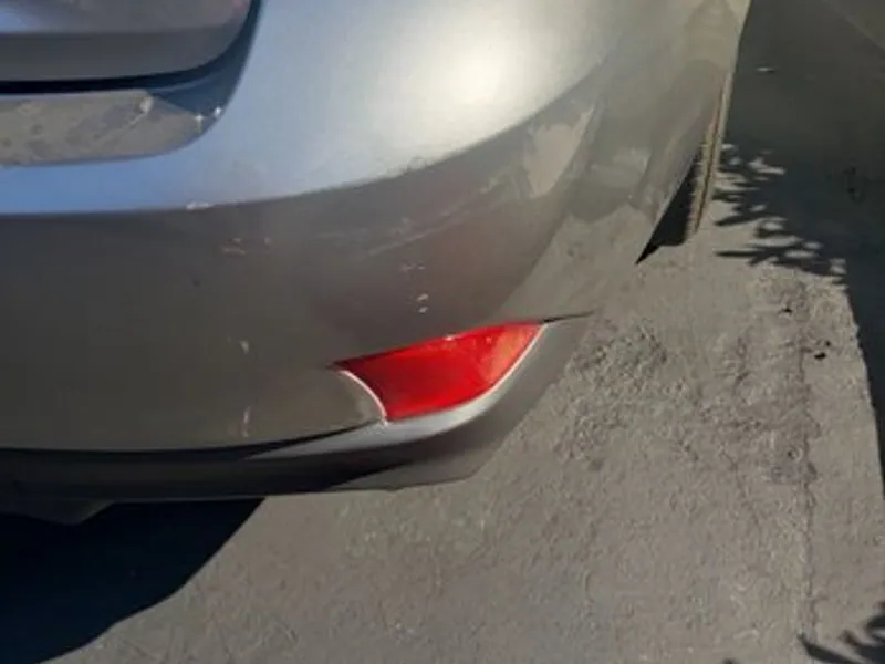 Champagne sedan rear bumper after dent repair